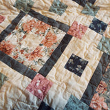 Block detail of handmade twin quilt in sage and rose