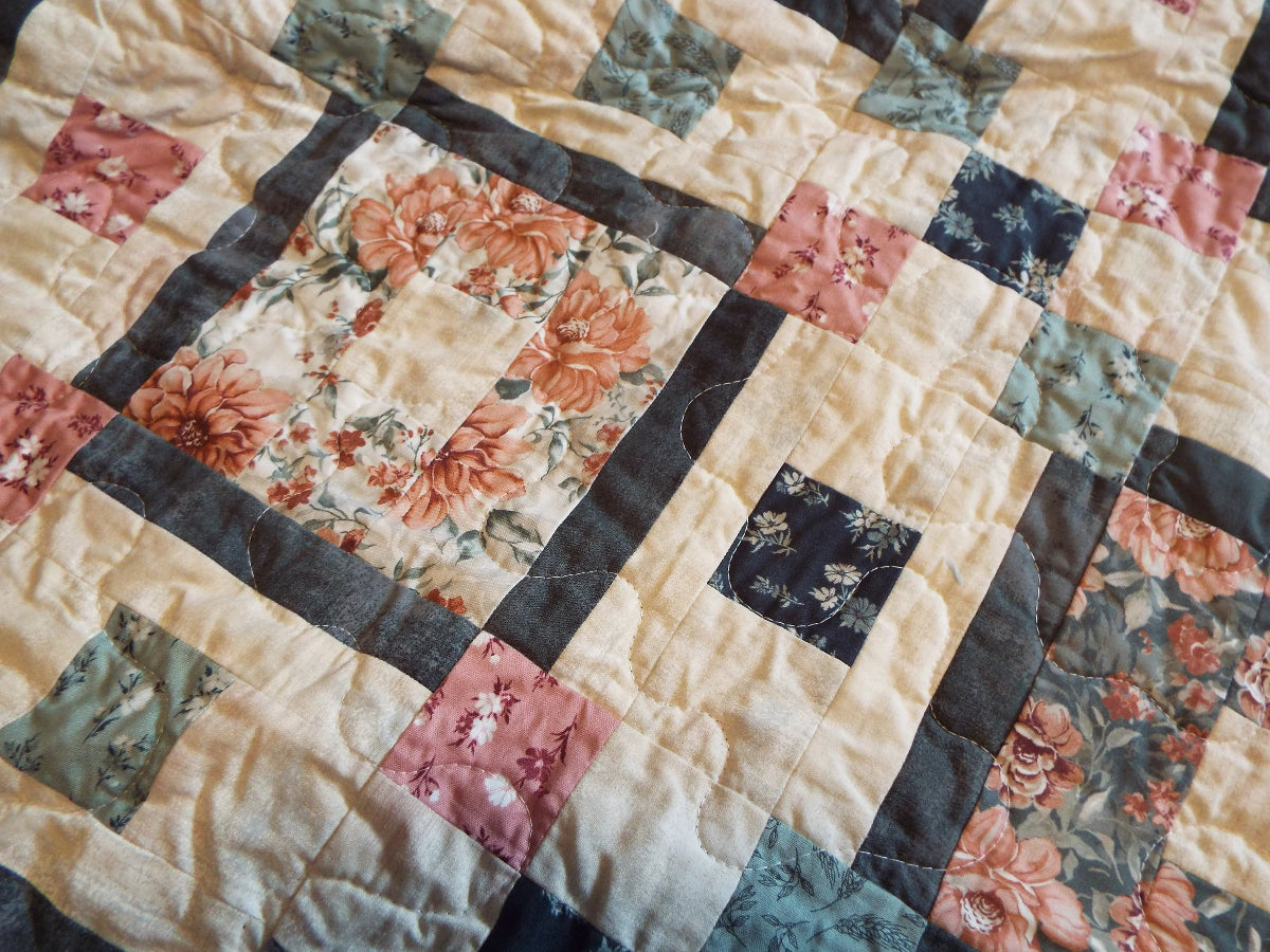 Block detail of handmade twin quilt in sage and rose