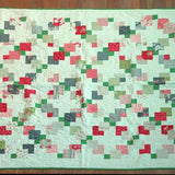 Flat lay of vibrant handmade twin quilt showing entire quilt