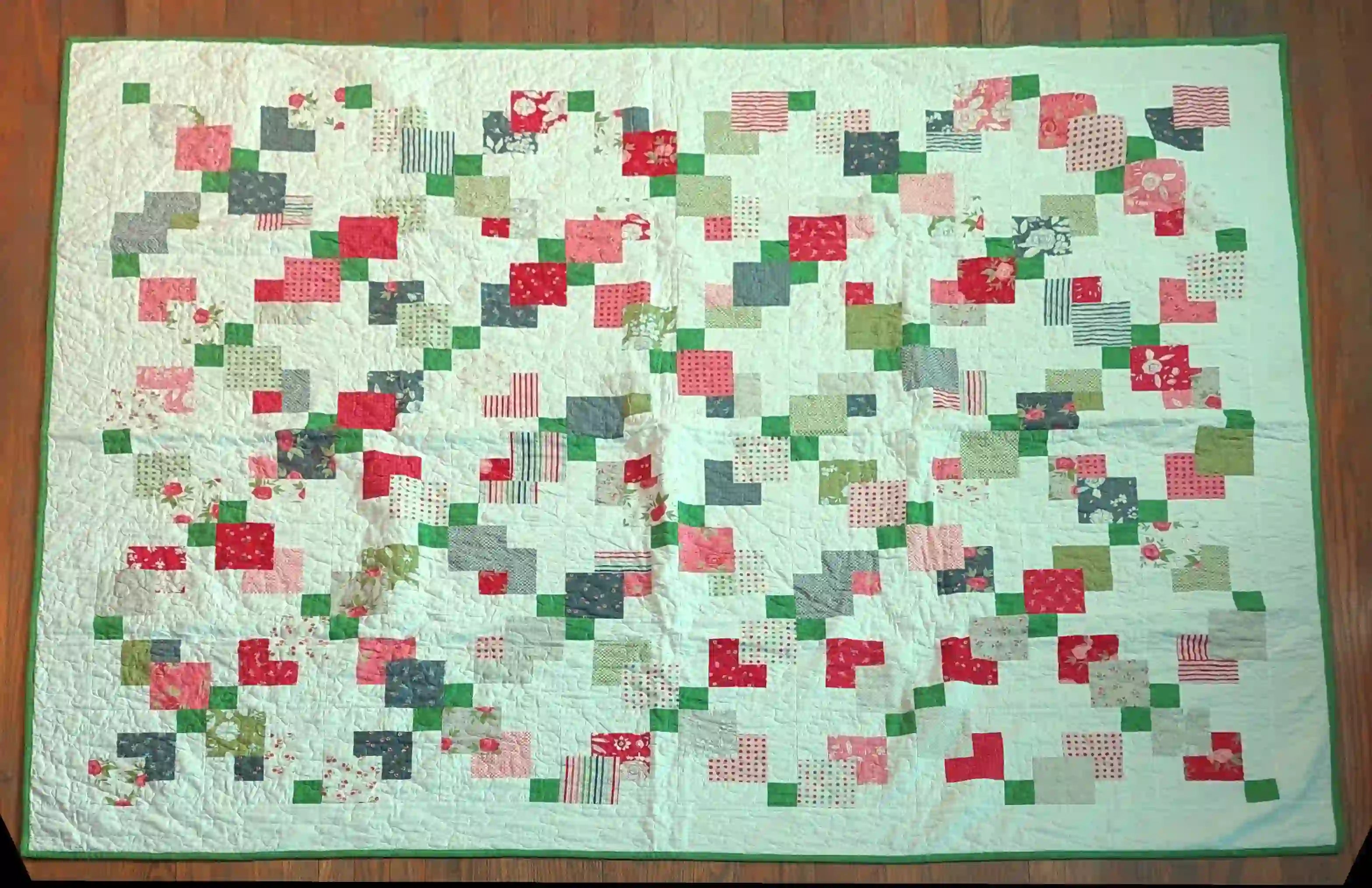 Flat lay of vibrant handmade twin quilt showing entire quilt