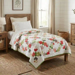 Vibrant handmade quilt shown on twin bed in farmhouse styled bedroom.