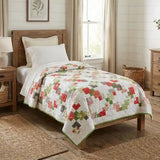 Vibrant handmade quilt shown on twin bed in farmhouse styled bedroom.