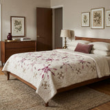 A styled bedroom scene featuring a wooden bed with Scarlet Correspondence Queen Quilt, styled with white pillows and a single dusty rose accent pillow.