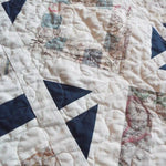 Detail shot showing stitching and texture of handmade lap quilt