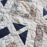 Detail shot showing stitching and texture of handmade lap quilt