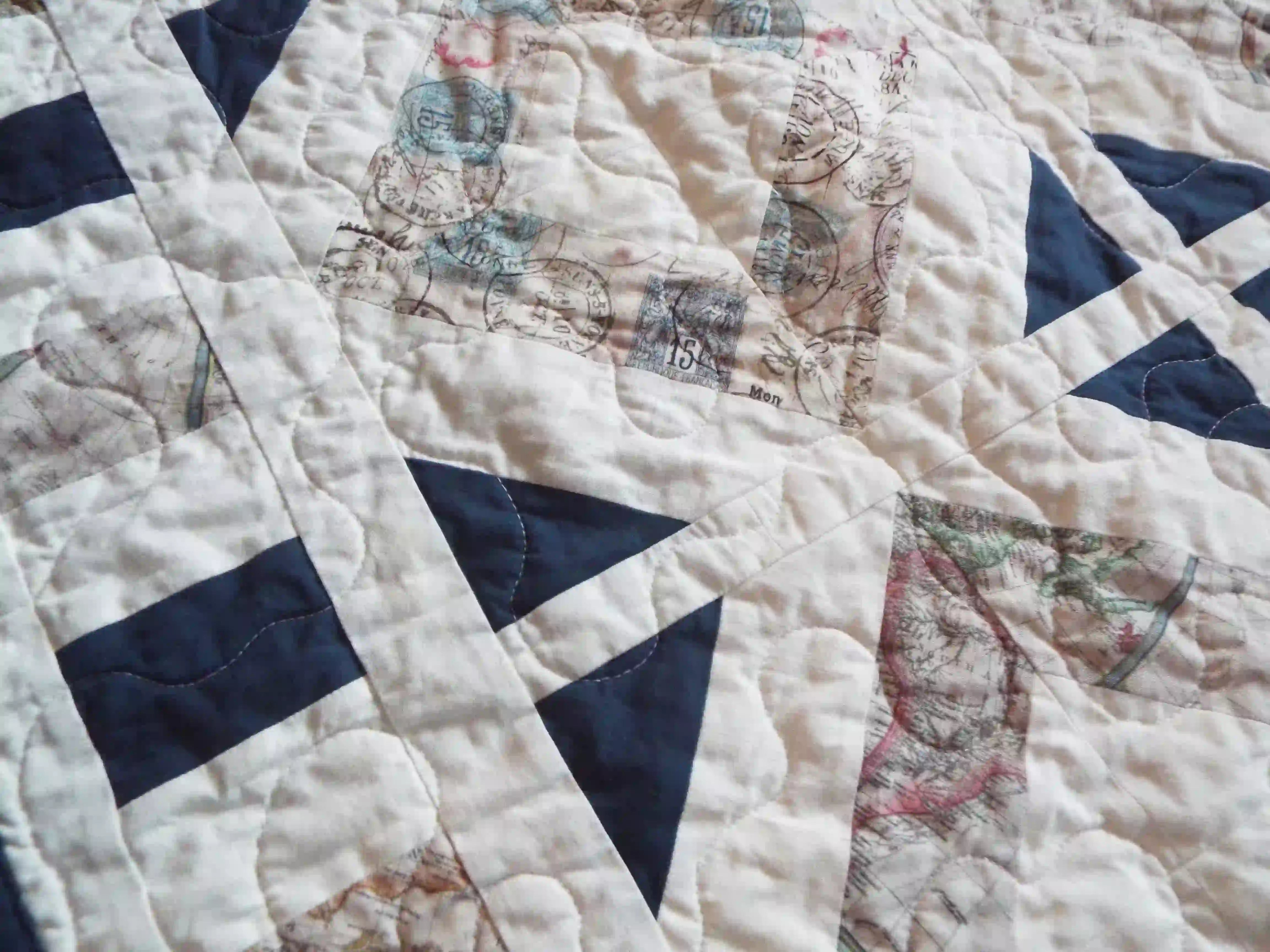 Detail shot showing stitching and texture of handmade lap quilt