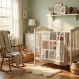 Handmade quilt shown over a light crib in a sage-colored nursery.