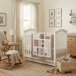 Handmade quilt shown in neutral nursery folded over crib side.