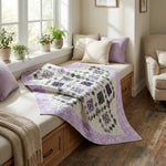 Evening Lattice lap quilt shown draped over a window seat in a neutrally decorated room