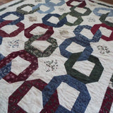 Angled lay of Winter Links Lap Quilt showing pattern.