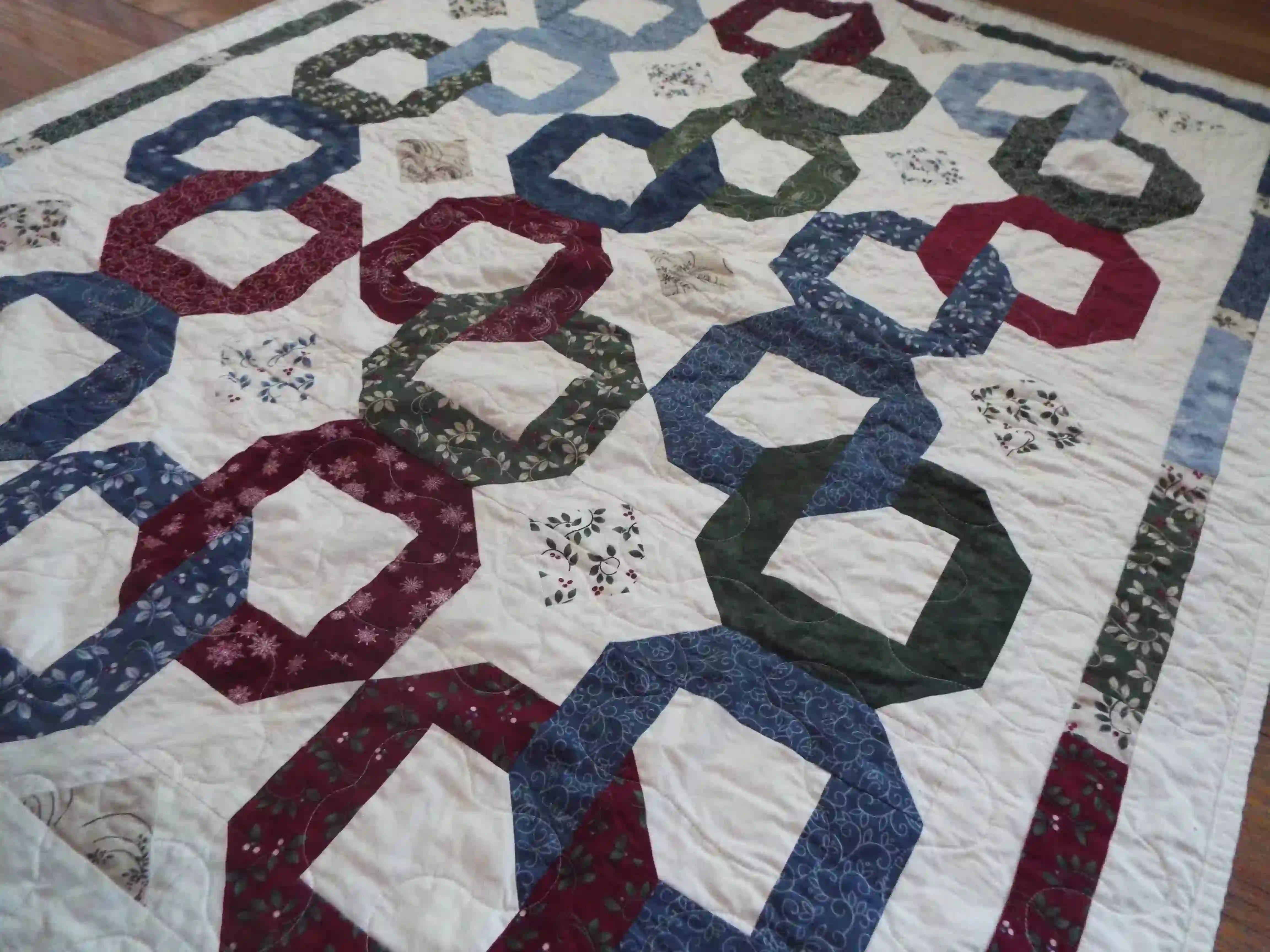 Angled lay of Winter Links Lap Quilt showing pattern.