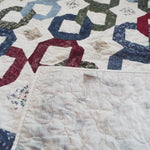 Corner flipped up for Winter Links Lap Quilt to show the backing.