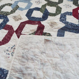 Corner flipped up for Winter Links Lap Quilt to show the backing.