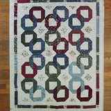 Flat lay of Winter Links Lap Quilt showing entire quilt.