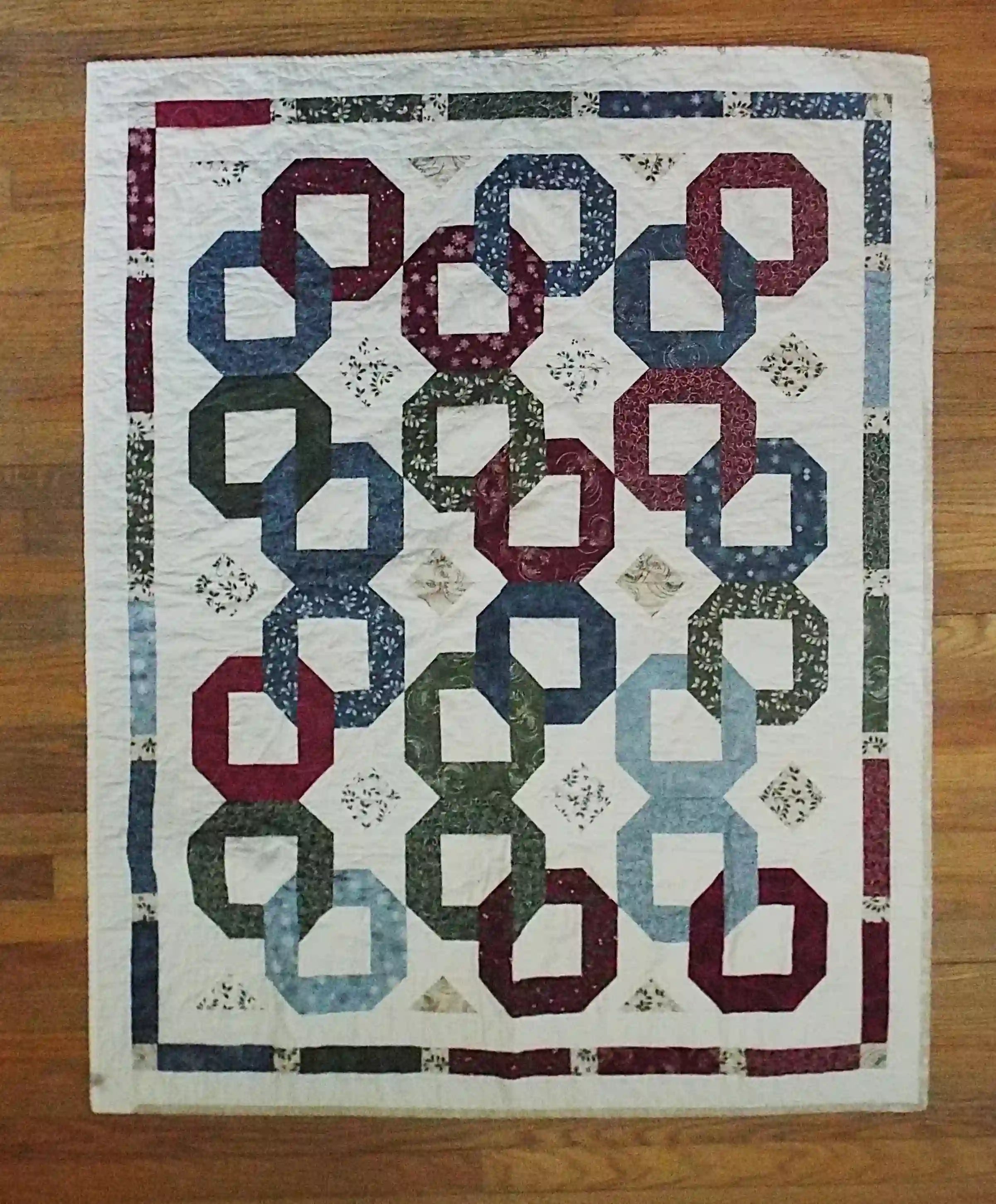 Flat lay of Winter Links Lap Quilt showing entire quilt.
