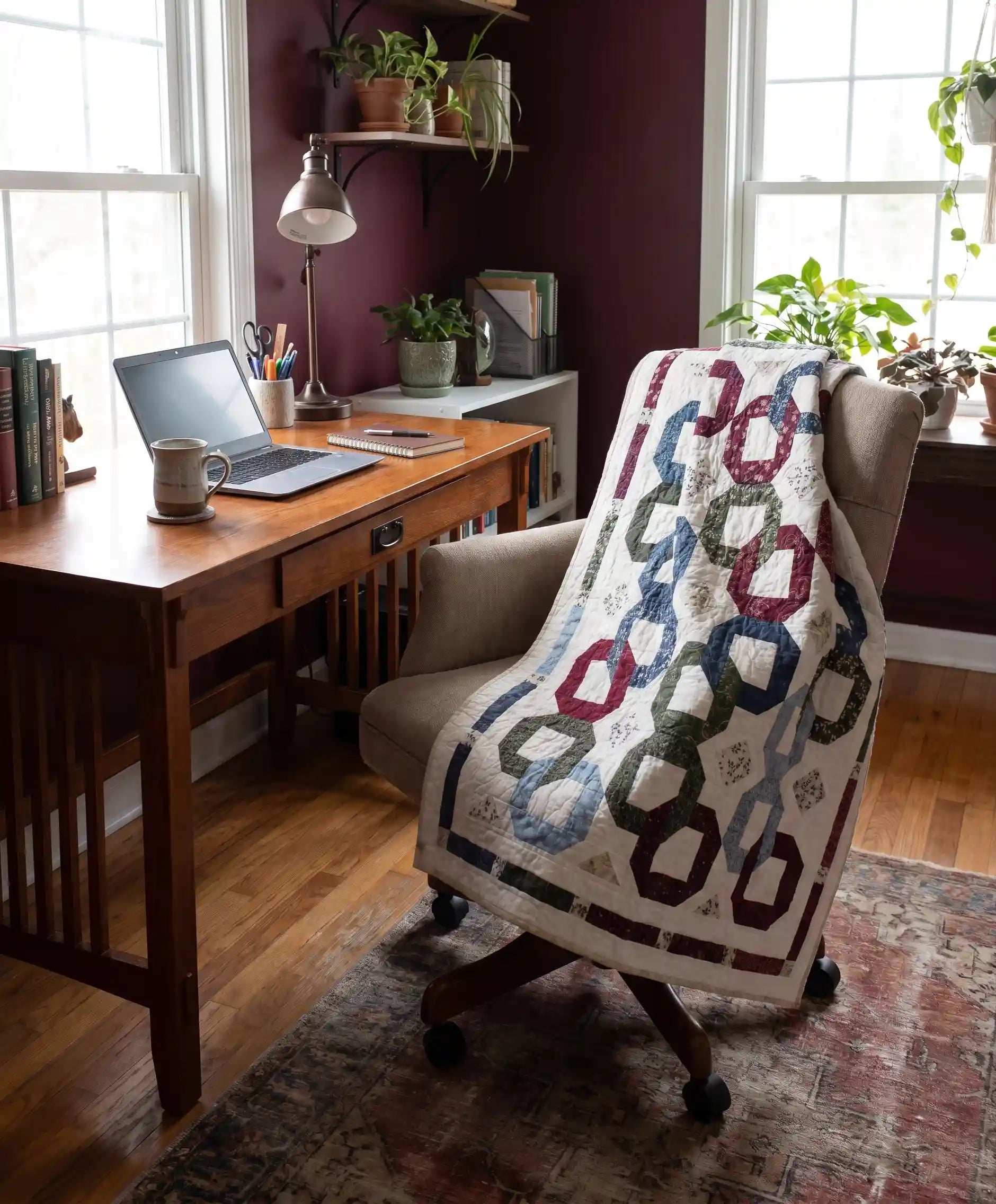 Winter Links Lap Quilt shown draped over a comfortable office chair in a home office.