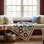 Winter Links Lap Quilt shown draped in a window seat.
