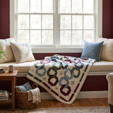 Winter Links Lap Quilt shown draped in a window seat.