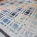 Angled lay of Woven Breeze showing closer detail of fabrics used in quilt.