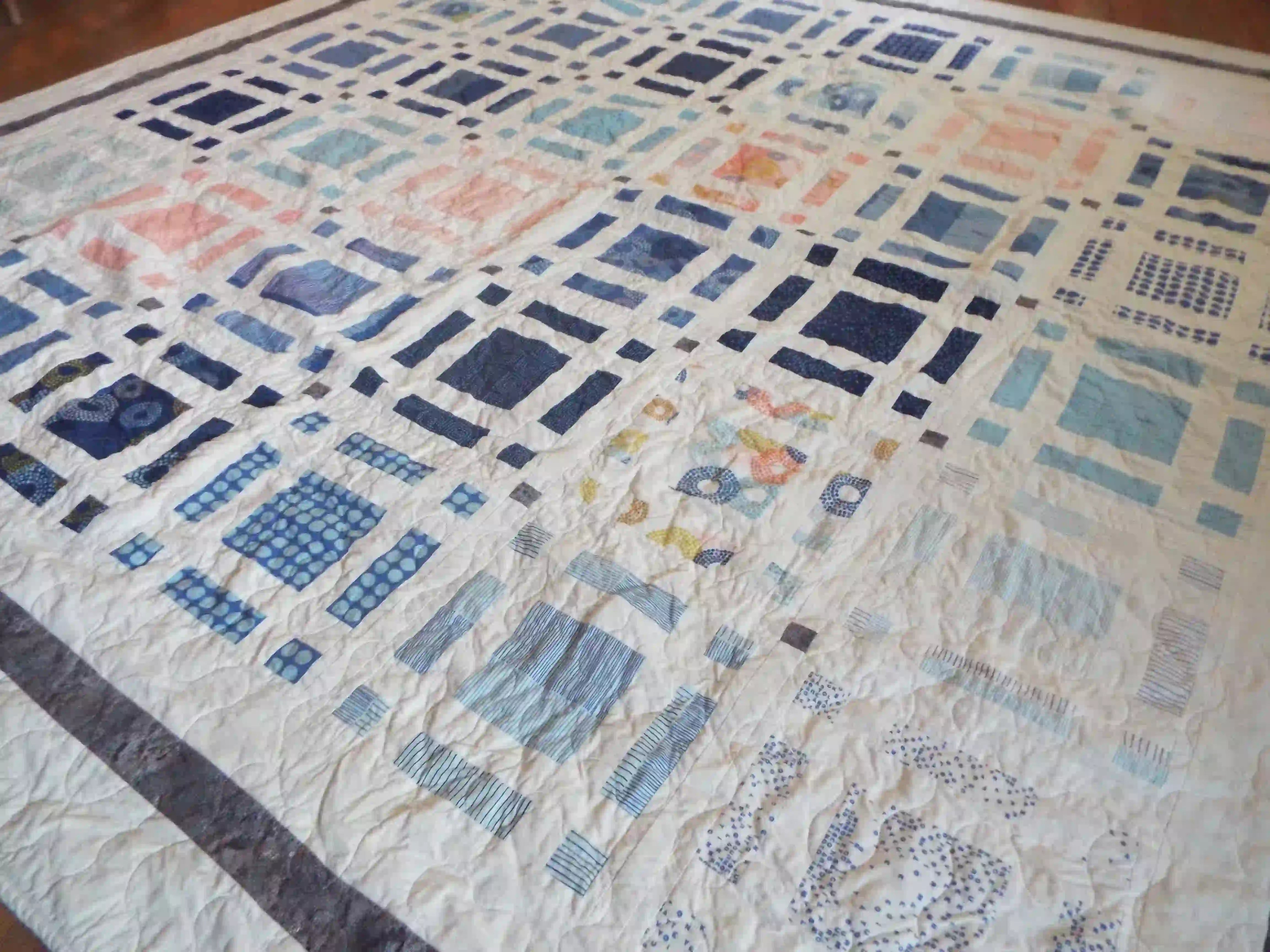 Angled lay of Woven Breeze showing closer detail of fabrics used in quilt.
