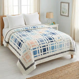 Woven Breeze queen on a queen bed in a coastal-inspired bedroom.