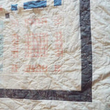 Detail of Woven Breeze queen showing binding, borders, and quilt stitching.