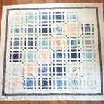 Flat lay of Woven Breeze queen showing entire pattern and fabrics.