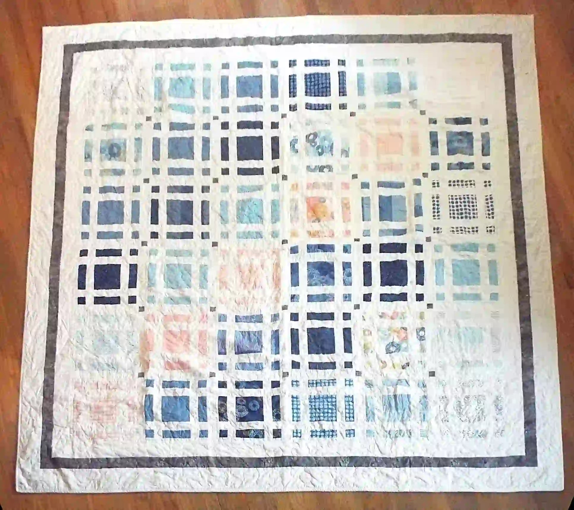 Flat lay of Woven Breeze queen showing entire pattern and fabrics.