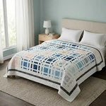 Woven Breeze queen shown in a simple bedroom with large windows and wooden floors.
