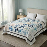 Woven Breeze queen shown in a simple bedroom with large windows and wooden floors.