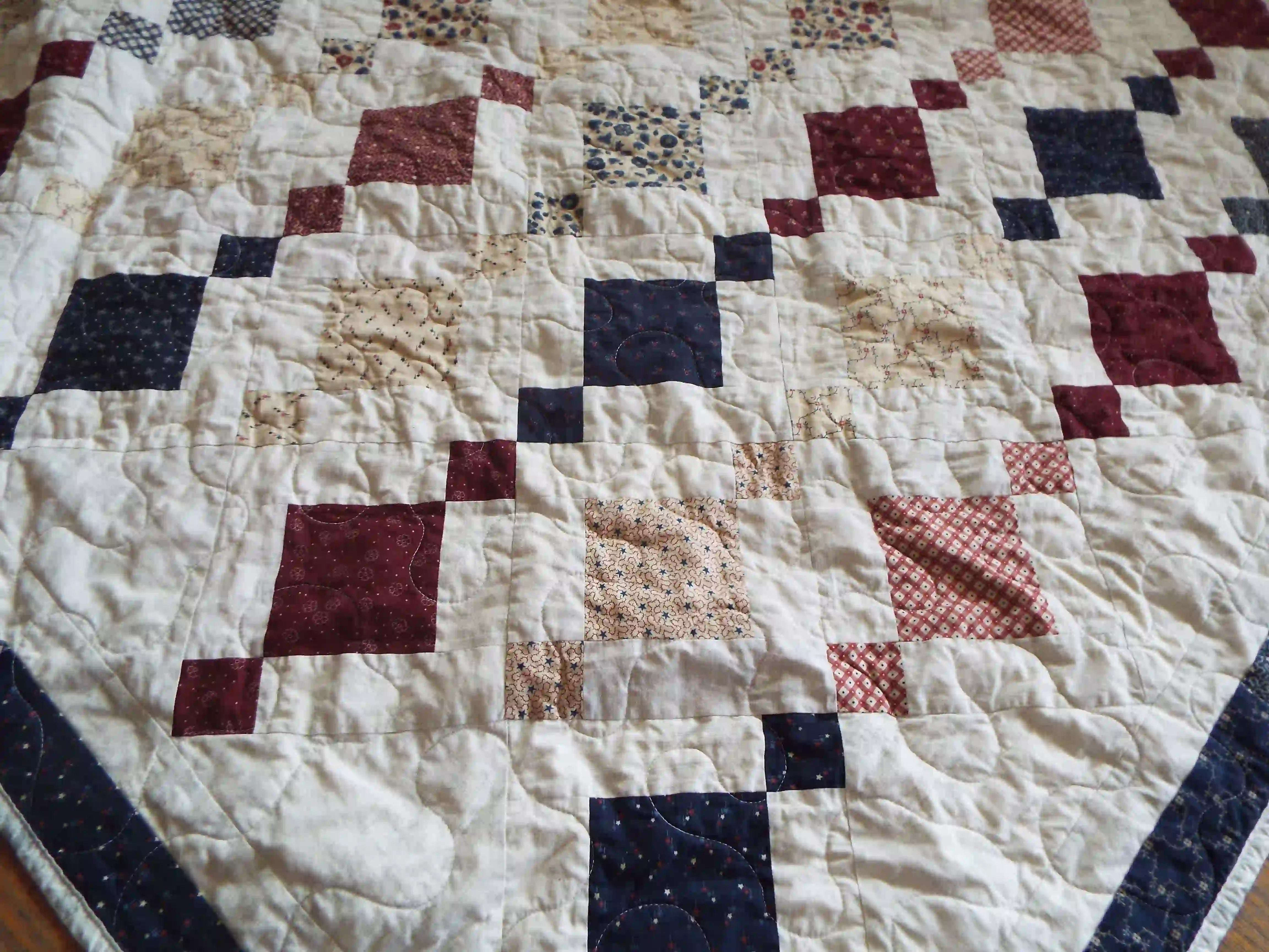 Woven Freedom lap quilt detail showing stitching and fabrics