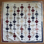 Woven Freedom lap quilt shown in its entirety in a flat lay