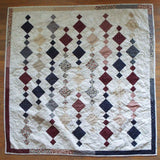 Woven Freedom lap quilt shown in its entirety in a flat lay