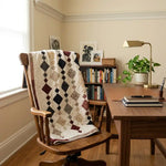 Woven Freedom lap quilt shown draped over the back of a home office chair
