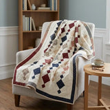 Woven Freedom lap quilt shown draped over a chair in a reading nook.