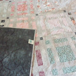 Woven Stillness queen quilt shown with corner flipped over for stitching detail and backing.