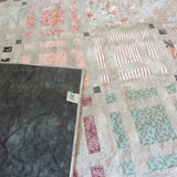 Woven Stillness queen quilt shown with corner flipped over for stitching detail and backing.